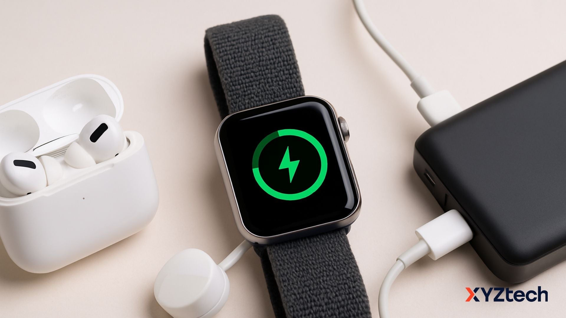An Apple watch that doesn't charge past 80%, earbuds, and a power bank on a desk.