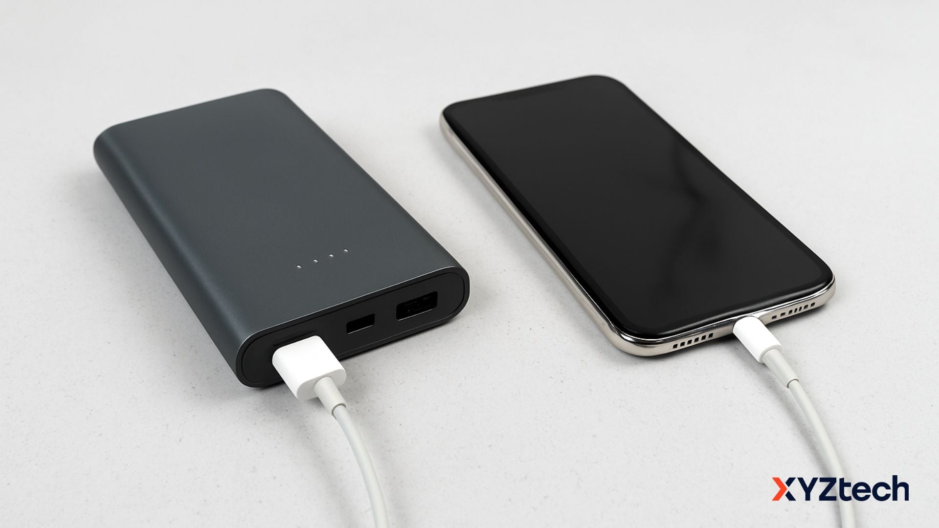 A portable charger not working charging a smartphone on a desk.