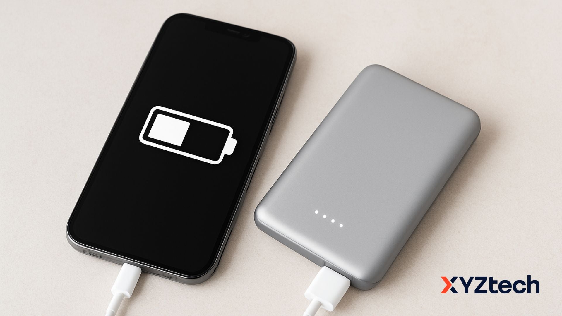 A gray power bank and a phone with 50% state of charge.